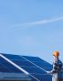 Man worker in the firld by the solar panels